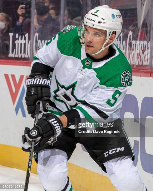 Andrej Sekera of the Dallas Stars passes the puck against the Detroit Red Wings during an NHL game at Little Caesars Arena on March 18, 2021 in...