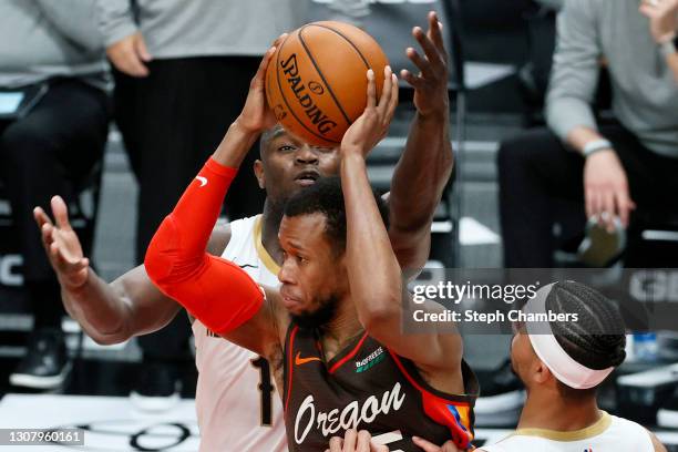 Rodney Hood of the Portland Trail Blazers maneuvers around Zion Williamson of the New Orleans Pelicans during the fourth quarter at Moda Center on...