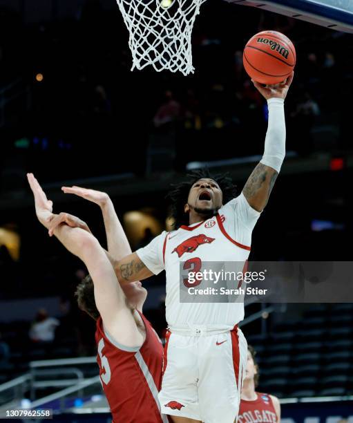 Desi Sills of the Arkansas Razorbacks drives to the basket as Jeff Woodward of the Colgate Raiders defends during the first half in the first round...