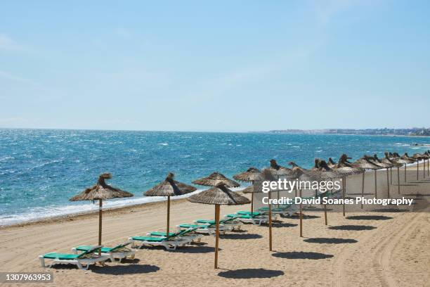 an empty beach in marbella, spain - マルベーリャ ストックフォトと画像