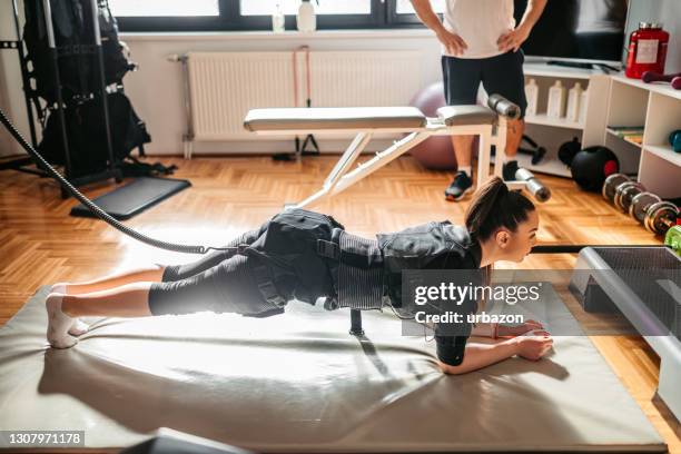 woman wearing ems suit on training - electrode stock pictures, royalty-free photos & images