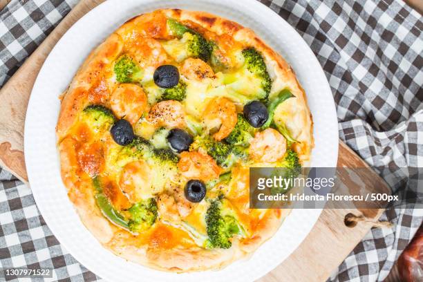 high angle view of pizza on table - vit pizza bildbanksfoton och bilder