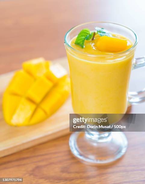 close-up of drink on table - mango juice stock-fotos und bilder