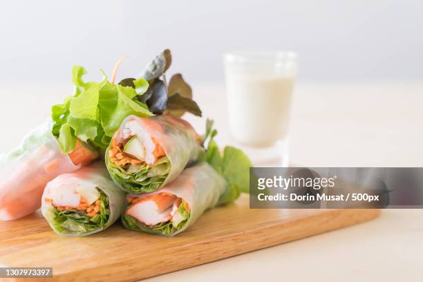 close-up of food on cutting board - spring roll stock pictures, royalty-free photos & images