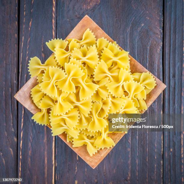 directly above shot of pasta on table - farfalle stock-fotos und bilder