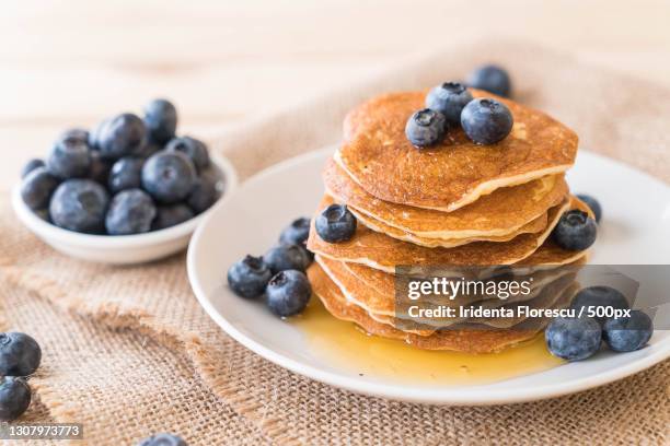 close-up of pancakes in plate on table - blueberry pancakes stock-fotos und bilder