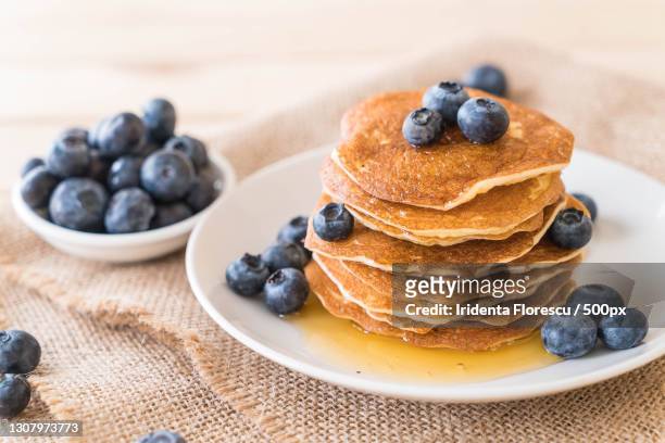 close-up of pancakes in plate on table - pancakes stockfoto's en -beelden