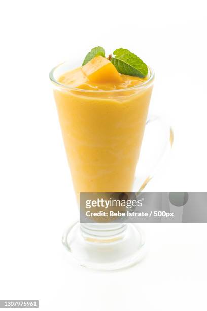 close-up of drink against white background - yellow smoothie stock pictures, royalty-free photos & images