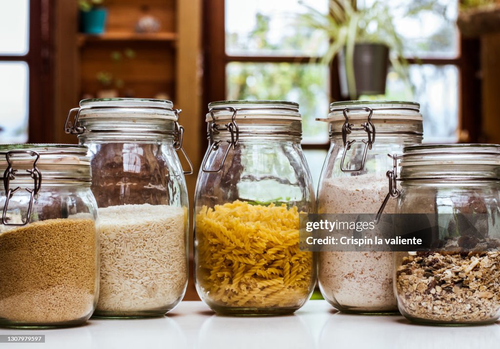 Glass jars with ingredients in the rustic kitchen