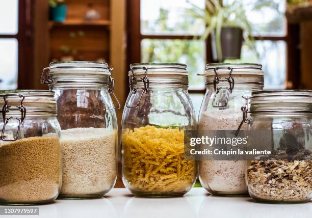 glass jars with ingredients in the rustic kitchen - voorraadkast stockfoto's en -beelden