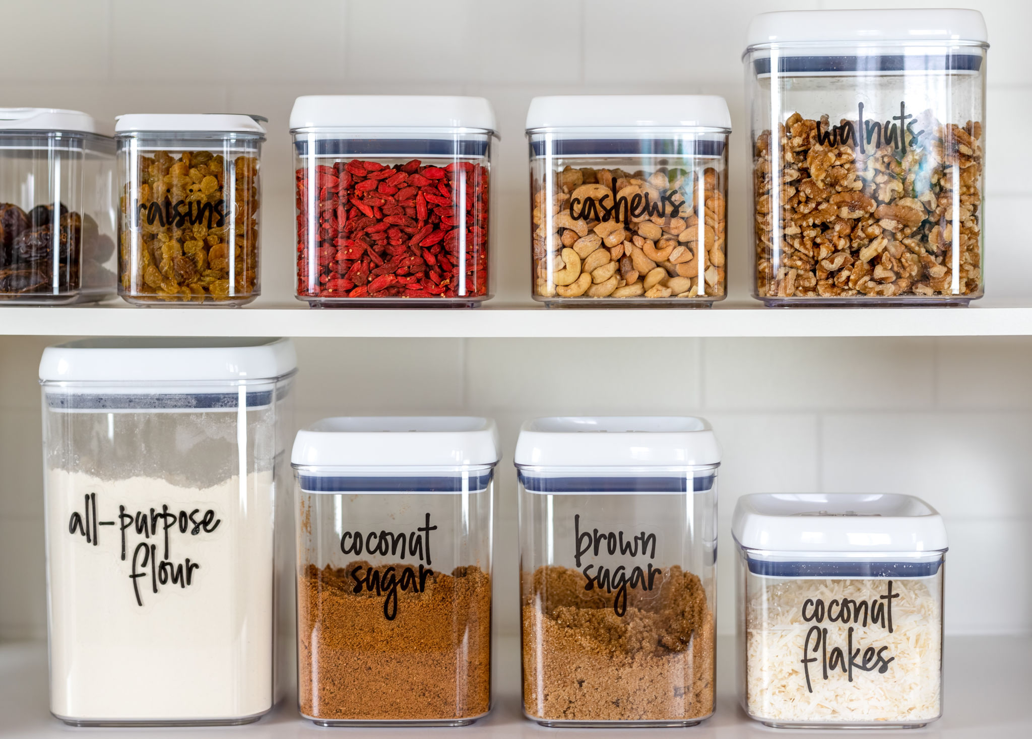 Neatly organized transparent canisters for baking ingredients Neatly organized transparent canisters for baking ingredients