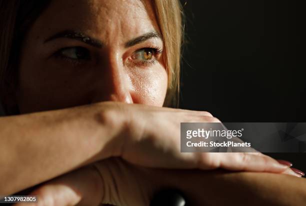 close up of woman thinking of something while resting after sport training at home - angry eyes stock pictures, royalty-free photos & images