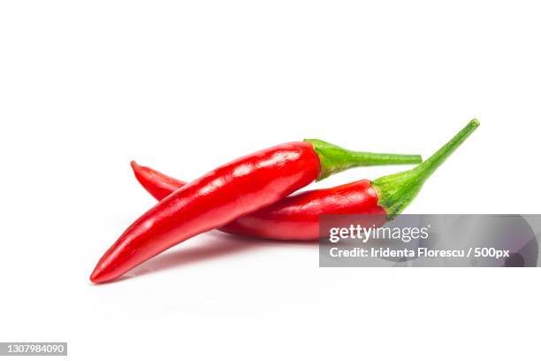 close-up of red chili pepper against white background - chili pepper on white stock pictures, royalty-free photos & images
