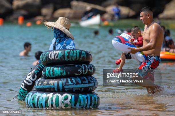 Man rents lifeguard donuts on Caleta beach that has no restrictions amid the coronavirus pandemic on March 19, 2021 in Acapulco, Mexico. Acapulco...