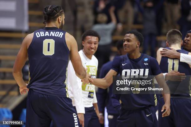 Kevin Obanor and Max Abmas of the Oral Roberts Golden Eagles react after defeating the Ohio State Buckeyes in overtime in the first round game of the...