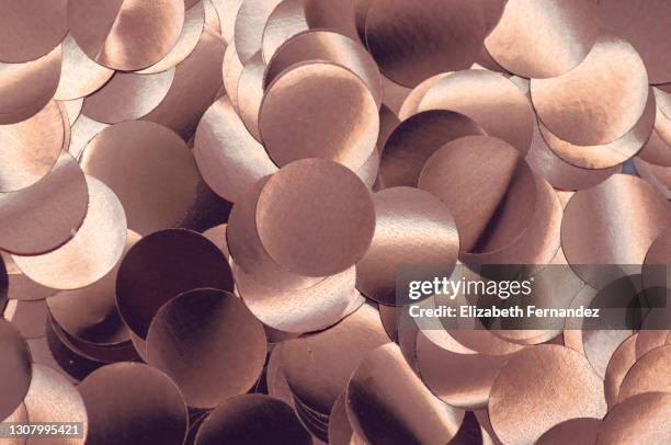 full frame of rose-gold confetti glowing - red gold party stock pictures, royalty-free photos & images