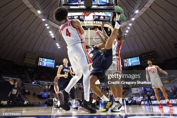 Kevin Obanor of the Oral Roberts Golden Eagles shoots against Duane Washington Jr. #4 of the Ohio State Buckeyes in overtime in the first round game...