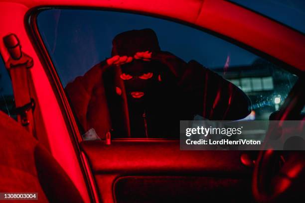 car thief looking through car window - hijack stock pictures, royalty-free photos & images
