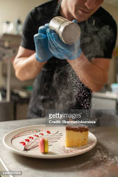 chef sprinkling powdered sugar on cheesecake - gentlemen art lunch stock pictures, royalty-free photos & images