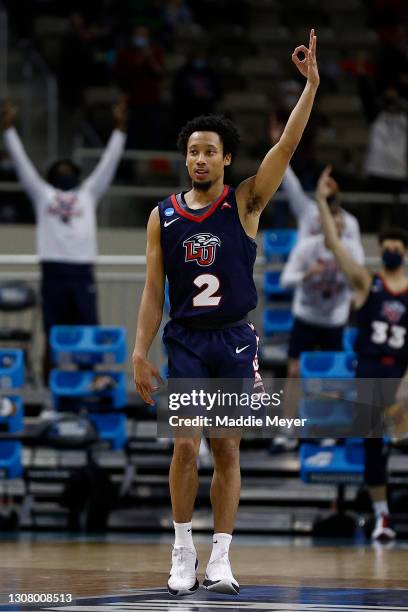 Darius McGhee of the Liberty Flames celebrates after a three point basket against the Oklahoma State Cowboys during the first half in the first round...