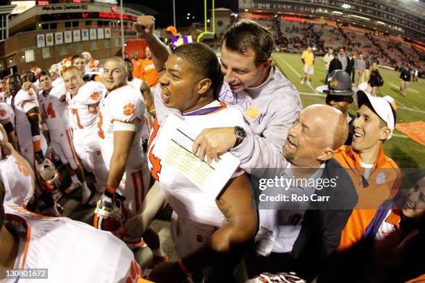 Head coach Dabo Swinney of the Clemson Tigers celebrates with guard Antoine McClain after the Tigers defeated the Maryland Terrapins 56-45 at Byrd...