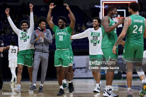 The North Texas Mean Green celebrate after beating the Purdue Boilermakers 78-69 in overtime in the first round game of the 2021 NCAA Men's...