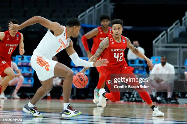 Jacob Young of the Rutgers Scarlet Knights handles the ball against Clyde Trapp of the Clemson Tigers in the second half in the first round game of...