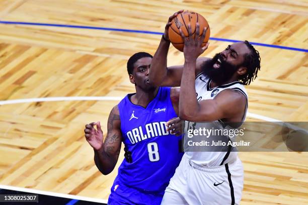 James Harden of the Brooklyn Nets draws the foul from Dwayne Bacon of the Orlando Magic in the second half at Amway Center on March 19, 2021 in...