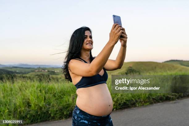 pregnant woman taking a selfie on the walk - 4g stock pictures, royalty-free photos & images