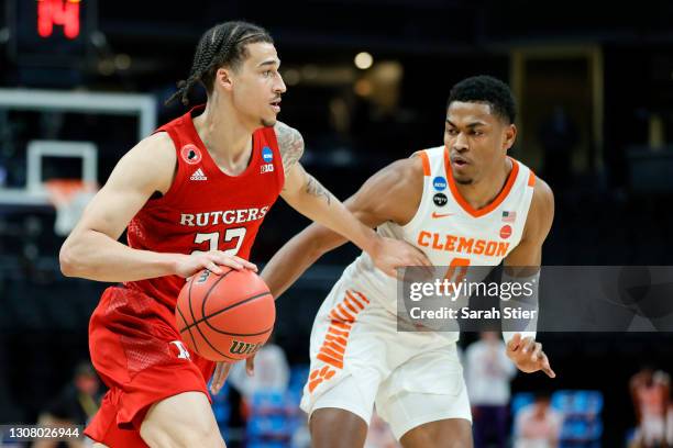 Caleb McConnell of the Rutgers Scarlet Knights handles the ball against Clyde Trapp of the Clemson Tigers in the second half in the first round game...