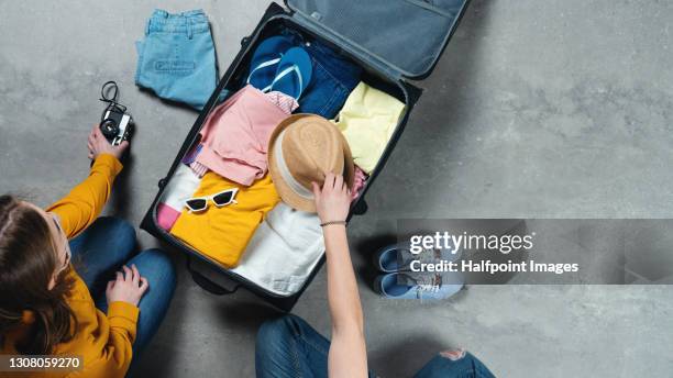 top view of young couple packing for summer holidays, coronavirus concept. - suitcase packing stockfoto's en -beelden