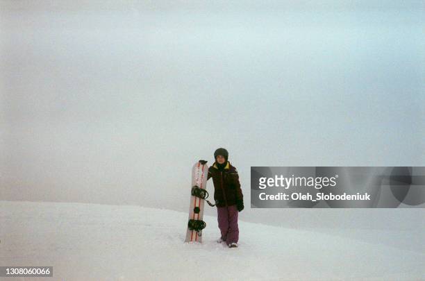 woman snowboarding in mountains - film darchive photos stock pictures, royalty-free photos & images