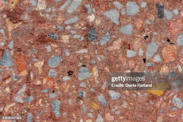 close up of terracotta colored terrazzo wiht grey and yellow pieces - terrazzo ストックフォトと画像