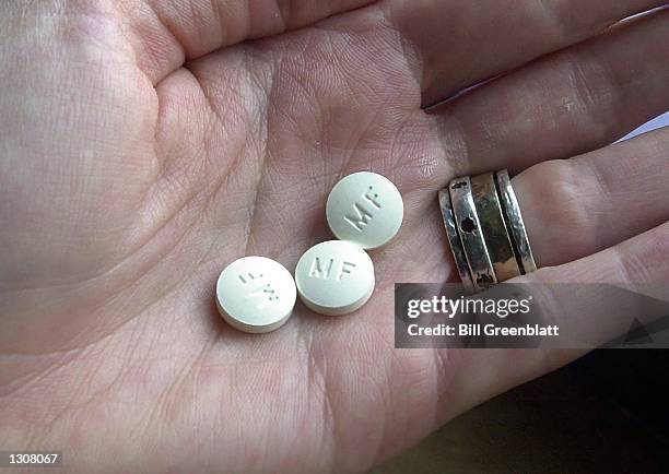 Three RU-486 Mifeprex abortion pills are held in a hand December 1, 2000 in Granite City, Illinois. The Hope Center for Women is the first area...