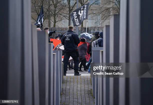 Antifa and leftist protesters march past the Holocaust Memorial as they demonstrate against gatherings of neo-Nazis nearby in the city center on...