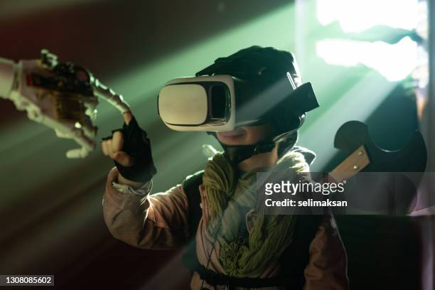 portrait of boy as fictional video game character interacting with cyborg robot - communication tools stock pictures, royalty-free photos & images
