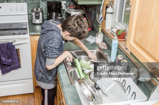 boy doing dishes - washing dishes stock pictures, royalty-free photos & images