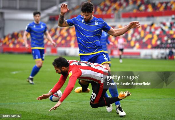 Saman Ghoddos of Brentford is challenged by Tobias Figueiredo of Nottingham Forest during the Sky Bet Championship match between Brentford and...