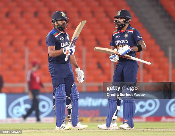 Rohit Sharma celebrates reaching his 50 along side Virat Kohli during the 5th T20 International between India and England at Narendra Modi Stadium on...