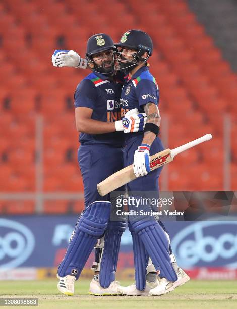 Rohit Sharma celebrates reaching his 50 along side Virat Kohli during the 5th T20 International between India and England at Narendra Modi Stadium on...