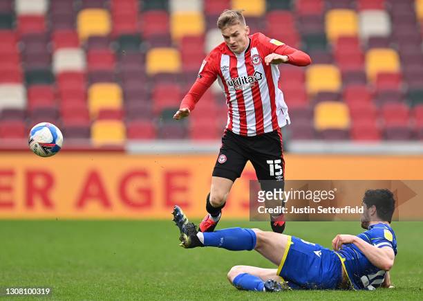 Marcus Forss of Brentford is challenged by Scott McKenna of Nottingham Forest during the Sky Bet Championship match between Brentford and Nottingham...