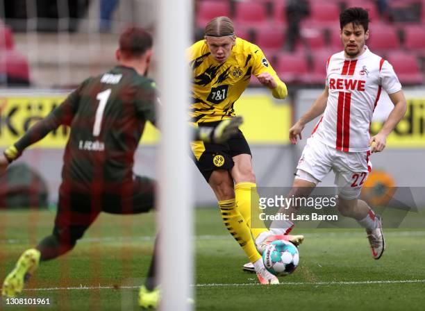 Erling Haaland of Borussia Dortmund scores their team's first goal past Timo Horn of 1.FC Koeln during the Bundesliga match between 1. FC Koeln and...