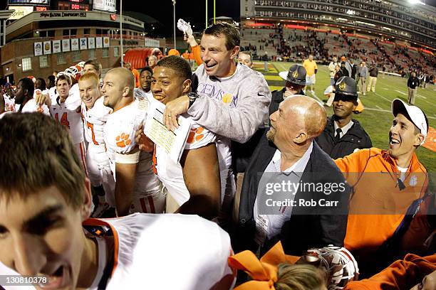 Head coach Dabo Swinney of the Clemson Tigers celebrates with guard Antoine McClain after the Tigers defeated the Maryland Terrapins 56-45 at Byrd...