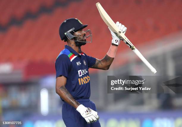 Hardik Pandya of India raises his bat as he leaves the field after the first innings during the 5th T20 International between India and England at...