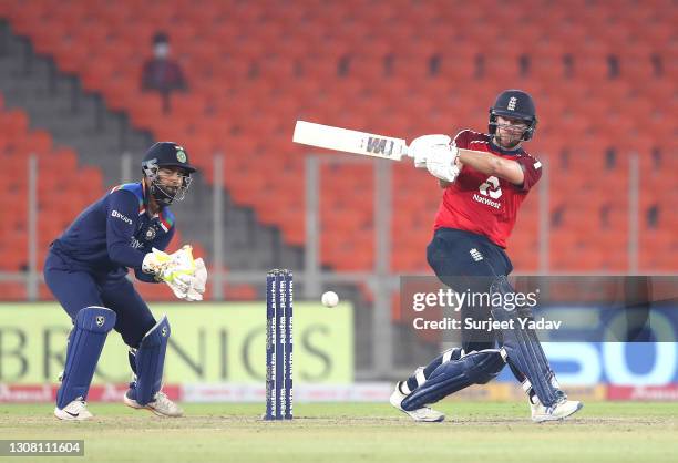 Dawid Malan of England hits runs as Rishabh Pant of India keeps wicket during the 5th T20 International between India and England at Narendra Modi...