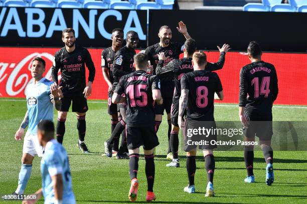 Karim Benzema of Real Madrid celebrates with teammates after scoring their team's second goal during the La Liga Santander match between RC Celta and...