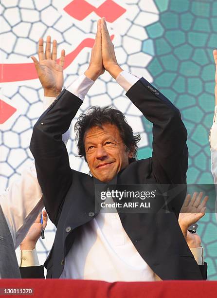 Pakistani politician and former cricketer Imran Khan gestures upon his arrival during a rally in Lahore on October 30, 2011. A crowd of thousands...