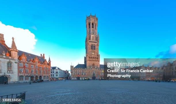 bruges market square with prominent belfry tower and town hall in the historic center of bruges, flanders, belgium - glockenturm stock-fotos und bilder