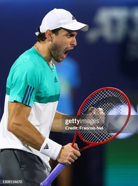 Aslan Karatsev of Russia celebrates beating Lloyd Harris of South Africa to win the men's singles Final match on day fourteen of the Dubai Duty Free...