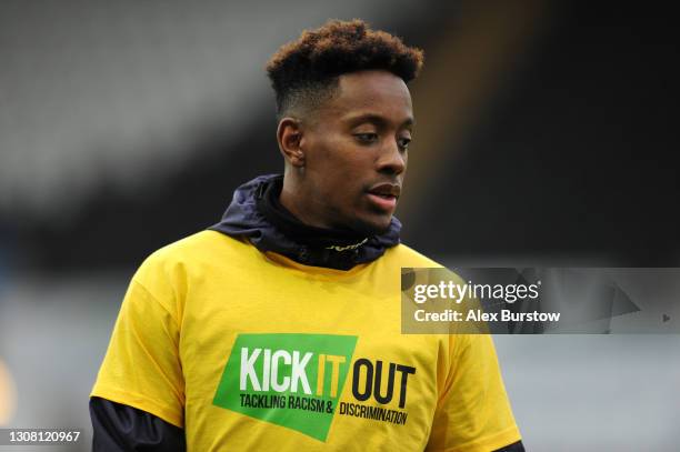 Jamal Lowe of Swansea City is seen wearing a "Kick It Out" anti-racism t-shirt during the warm up prior to the Sky Bet Championship match between...